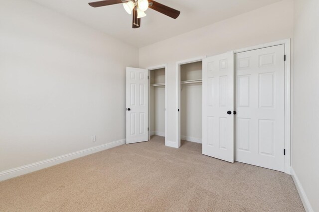 2261 Magill Ave, Clovis, CA 93611 - unfurnished bedroom featuring light carpet, two closets, and ceiling fan