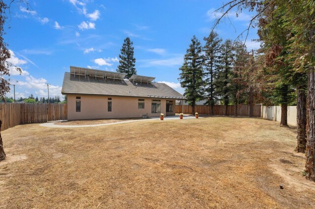 2261 Magill Ave, Clovis, CA 93611 - back of house featuring a fenced backyard, a patio, stucco siding, and a tiled roof
