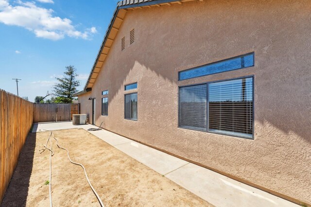 2261 Magill Ave, Clovis, CA 93611 - view of side of property with stucco siding, a fenced backyard, and a patio