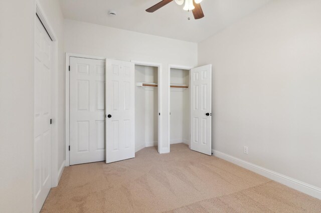 2261 Magill Ave, Clovis, CA 93611 - unfurnished bedroom with carpet, multiple closets, and ceiling fan