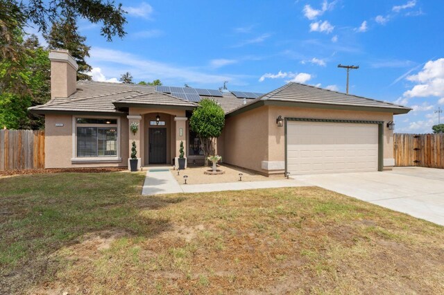 2261 Magill Ave, Clovis, CA 93611 - single story home with stucco siding, a chimney, concrete driveway, solar panels, and a garage