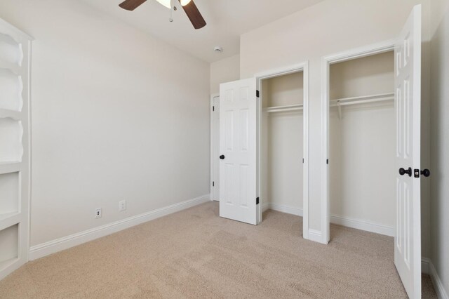 2261 Magill Ave, Clovis, CA 93611 - unfurnished bedroom featuring carpet, two closets, and a ceiling fan