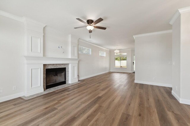 2261 Magill Ave, Clovis, CA 93611 - unfurnished living room with a ceiling fan, a fireplace with flush hearth, ornamental molding, wood finished floors, and a chandelier