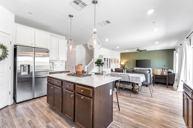 827 Vintage Ave, Clovis, CA 93619 - kitchen featuring stainless steel fridge with ice dispenser, a kitchen breakfast bar, a ceiling fan, light wood finished floors, and light countertops