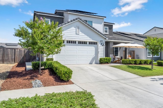 827 Vintage Ave, Clovis, CA 93619 - traditional-style home with a garage, roof mounted solar panels, and concrete driveway