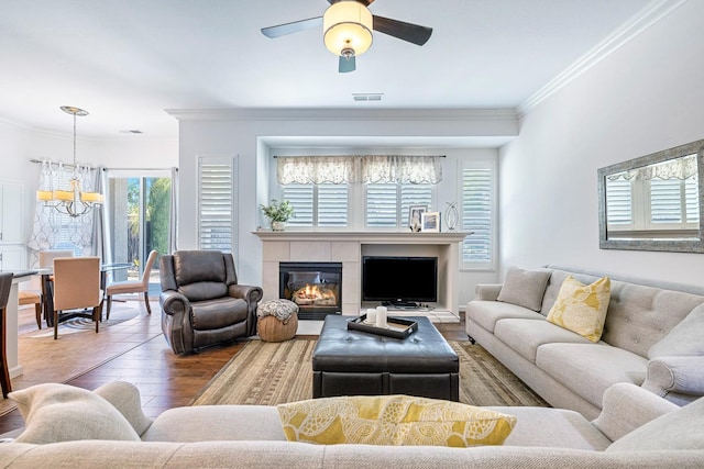 2549 Whiteash Ave, Clovis, CA 93619 - living area with a chandelier, crown molding, hardwood / wood-style floors, a ceiling fan, and a glass covered fireplace