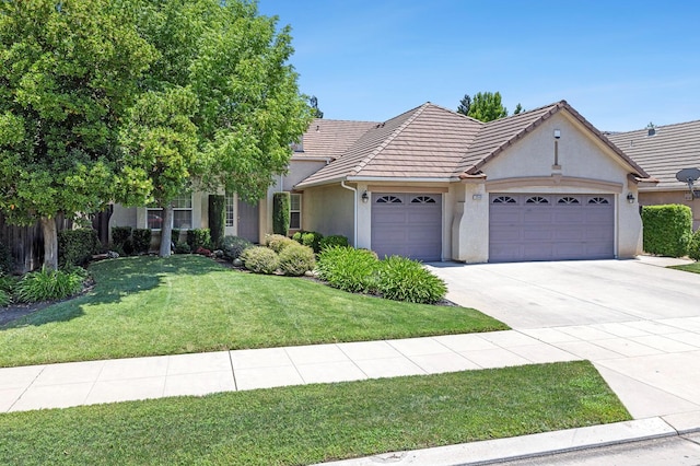 2549 Whiteash Ave, Clovis, CA 93619 - view of front of house with an attached garage, stucco siding, a front lawn, driveway, and a tiled roof