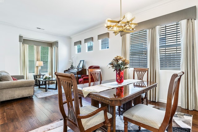 2549 Whiteash Ave, Clovis, CA 93619 - dining area with crown molding, a chandelier, and dark wood-style floors