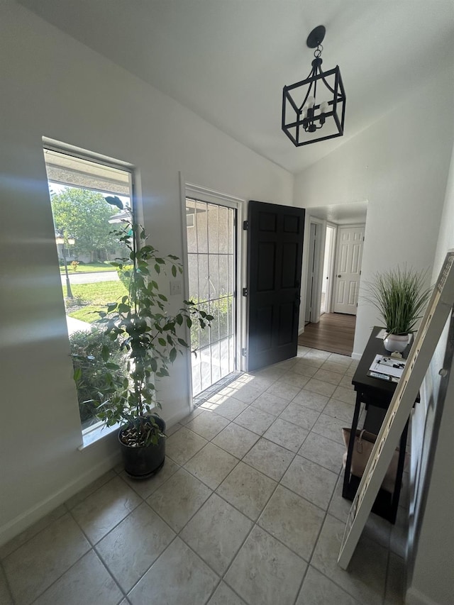 6536 N Tracy Ave, Fresno, CA 93722 - foyer entrance featuring lofted ceiling, light tile patterned floors, and a chandelier