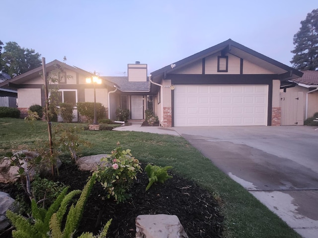 6536 N Tracy Ave, Fresno, CA 93722 - mid-century modern home with an attached garage, driveway, a chimney, a front yard, and brick siding