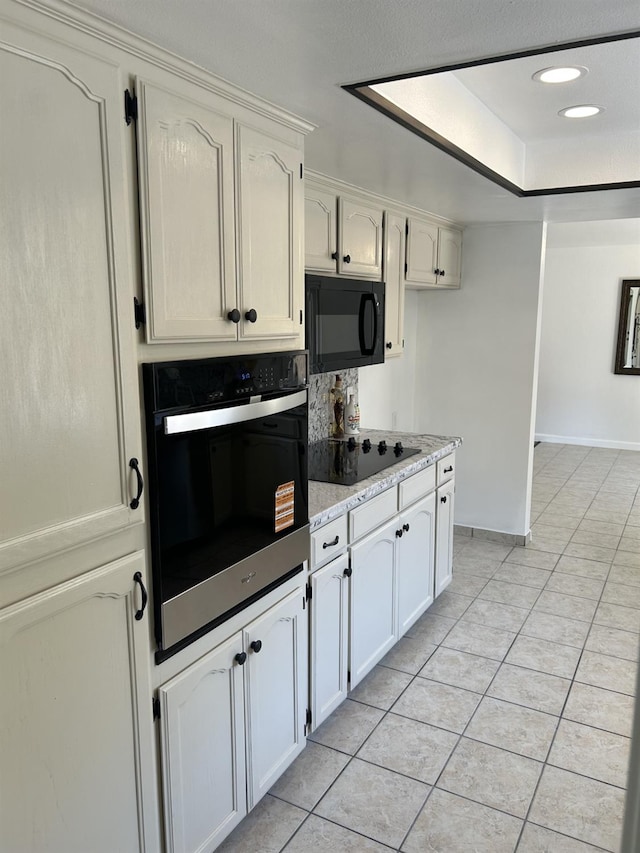 6536 N Tracy Ave, Fresno, CA 93722 - kitchen featuring black appliances, light tile patterned floors, light stone countertops, and recessed lighting