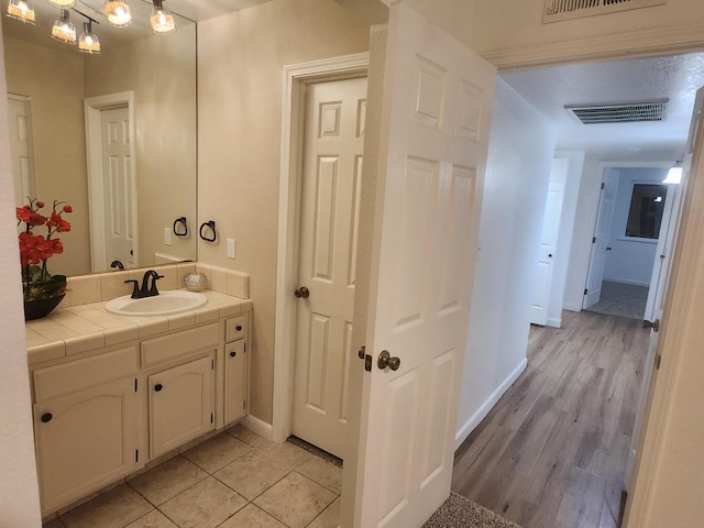 6536 N Tracy Ave, Fresno, CA 93722 - bathroom featuring vanity and baseboards