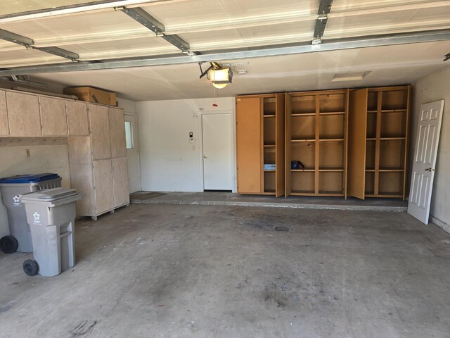 1229 W Bullard Ave Unit 105, Fresno, CA 93711 - garage featuring a garage door opener