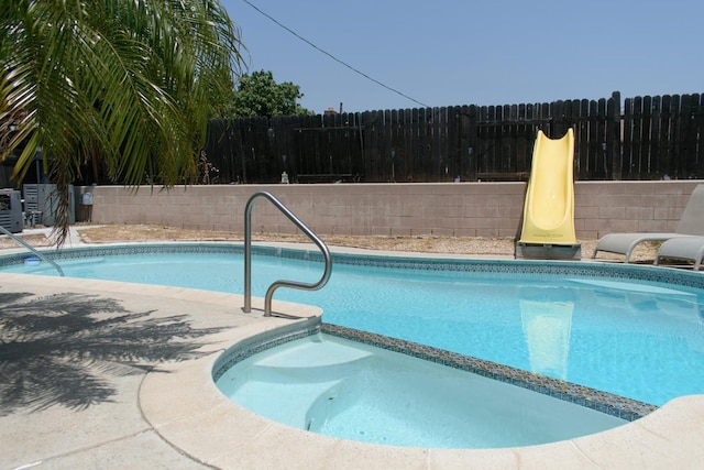19244 W Casmalia, Rialto, CA 92377 - view of pool featuring a fenced backyard, a pool with connected hot tub, and a patio area