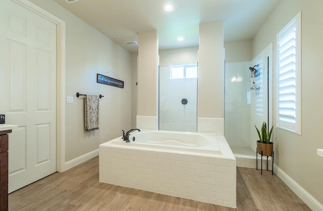 2047 Menlo Ave, Clovis, CA 93611 - full bathroom featuring a garden tub, wood finished floors, tiled shower, vanity, and recessed lighting
