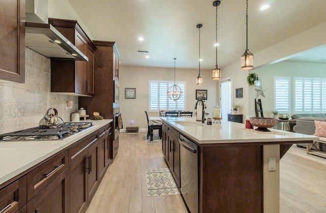 2047 Menlo Ave, Clovis, CA 93611 - kitchen featuring appliances with stainless steel finishes, wall chimney exhaust hood, dark brown cabinetry, light countertops, and recessed lighting
