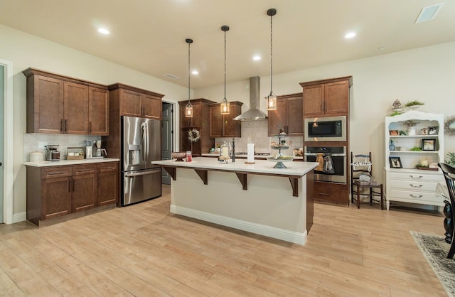 2047 Menlo Ave, Clovis, CA 93611 - kitchen featuring stainless steel appliances, wall chimney range hood, decorative backsplash, light countertops, and recessed lighting