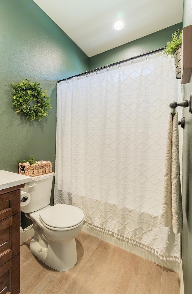 2047 Menlo Ave, Clovis, CA 93611 - bathroom featuring wood finished floors, vanity, and a shower with curtain