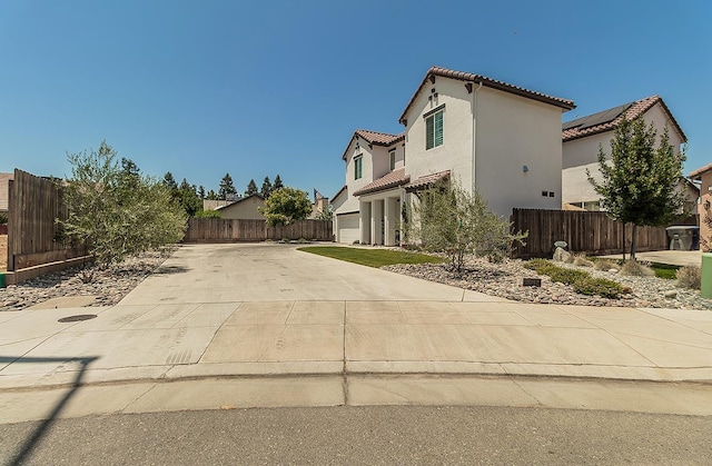 2047 Menlo Ave, Clovis, CA 93611 - view of side of home with a tiled roof, concrete driveway, stucco siding, and an attached garage