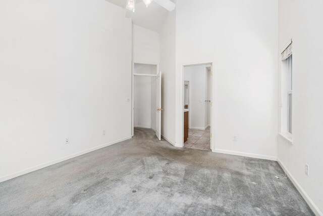 10643 N Tea Party Ln, Fresno, CA 93730 - unfurnished bedroom featuring carpet flooring and a towering ceiling