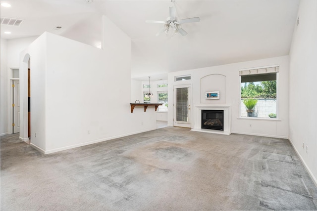 10643 N Tea Party Ln, Fresno, CA 93730 - unfurnished living room with carpet flooring, plenty of natural light, ceiling fan, arched walkways, and recessed lighting