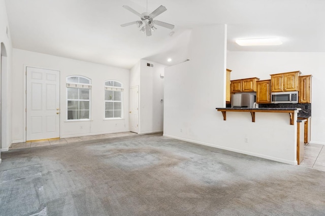 10643 N Tea Party Ln, Fresno, CA 93730 - unfurnished living room with a ceiling fan, light carpet, and high vaulted ceiling