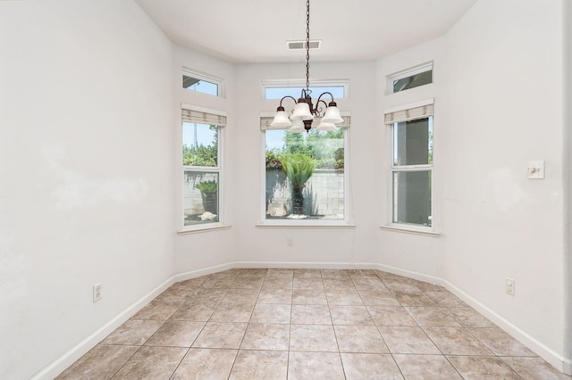 10643 N Tea Party Ln, Fresno, CA 93730 - unfurnished dining area with plenty of natural light, a chandelier, and light tile patterned flooring