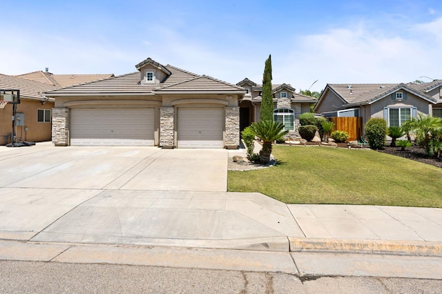 10643 N Tea Party Ln, Fresno, CA 93730 - view of front of home with stone siding, an attached garage, driveway, and stucco siding
