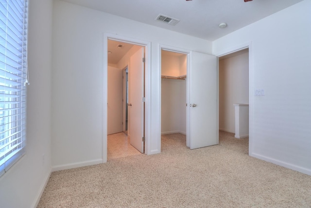 2062 Dunbar Way, Dinuba, CA 93618 - unfurnished bedroom featuring carpet flooring, a walk in closet, and a closet