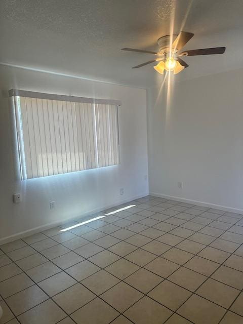 2967 E Iowa Ave, Fresno, CA 93701 - spare room featuring ceiling fan and light tile patterned flooring