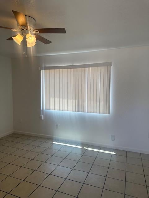 2967 E Iowa Ave, Fresno, CA 93701 - spare room with light tile patterned floors and a ceiling fan
