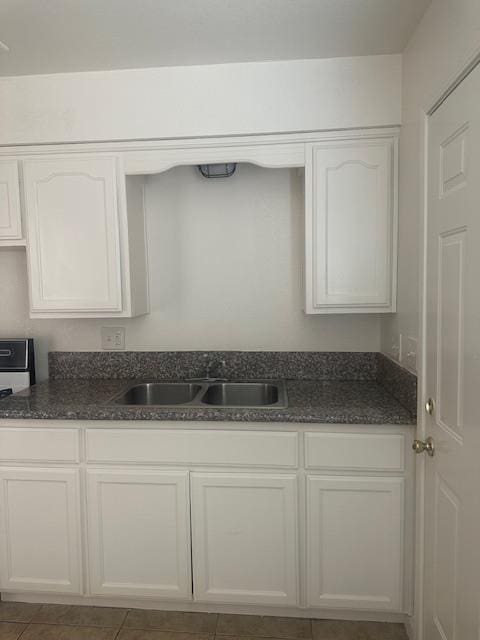 2967 E Iowa Ave, Fresno, CA 93701 - kitchen featuring dark stone counters, stove, white cabinetry, and tile patterned floors