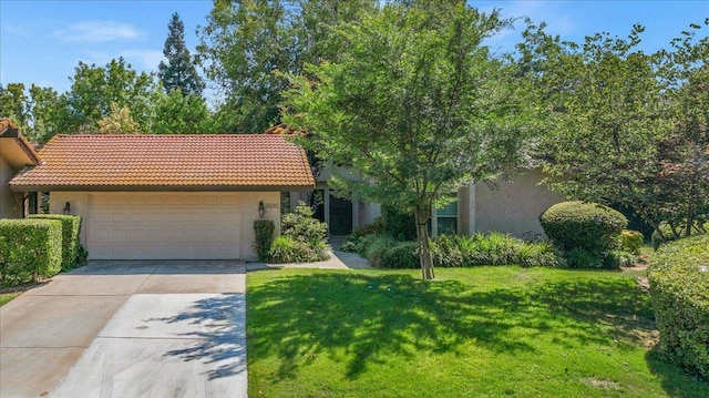 5532 N El Adobe Dr, Fresno, CA 93711 - view of front of home with stucco siding, a tiled roof, an attached garage, and concrete driveway