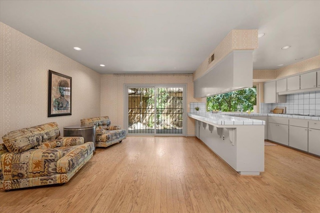 5532 N El Adobe Dr, Fresno, CA 93711 - living area with light wood-type flooring, wallpapered walls, and recessed lighting