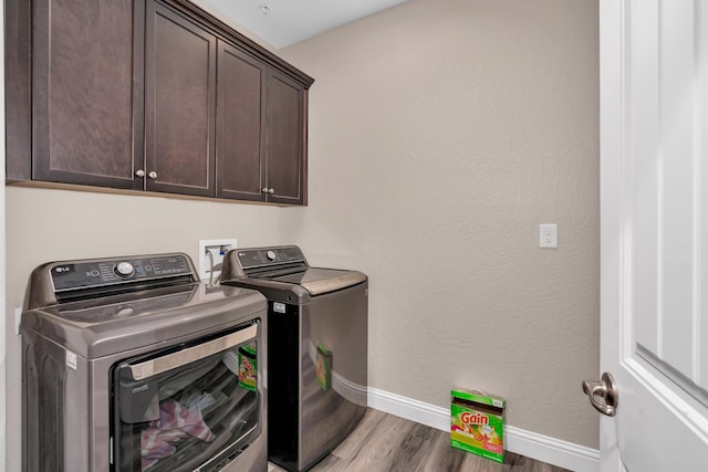 1160 Summit Ct, Madera, CA 93638 - washroom with washer and dryer, cabinet space, and wood finished floors
