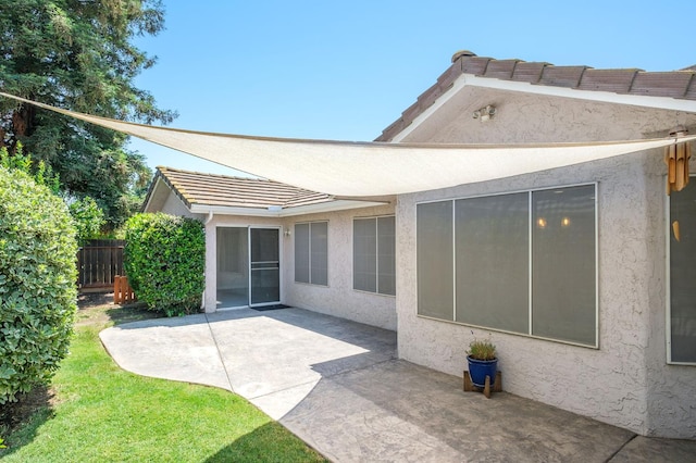 841 Whittier Ave, Clovis, CA 93611 - rear view of property featuring stucco siding, a patio area, and a tile roof