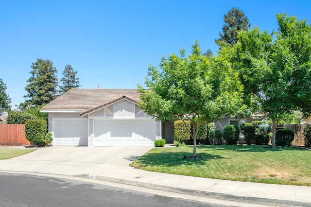 841 Whittier Ave, Clovis, CA 93611 - view of front facade featuring a garage, concrete driveway, a tile roof, and stucco siding