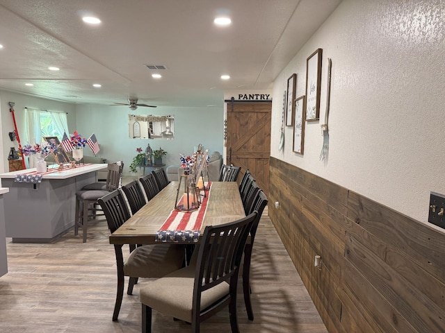 605 E Davis Dr, Dinuba, CA 93618 - dining room featuring a barn door, recessed lighting, wood finished floors, and ceiling fan