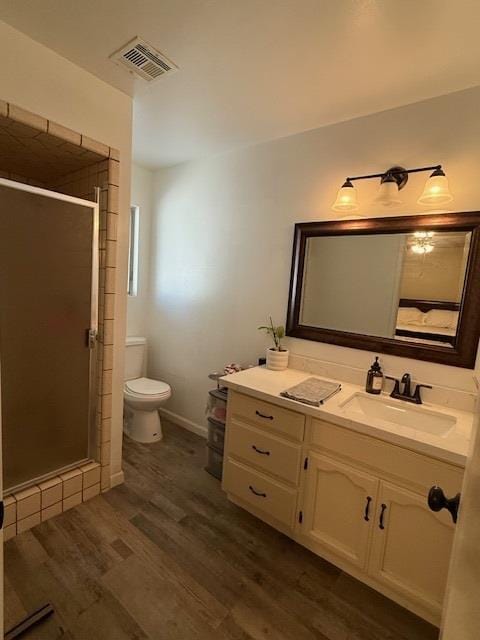 605 E Davis Dr, Dinuba, CA 93618 - full bath featuring wood finished floors, vanity, and a stall shower