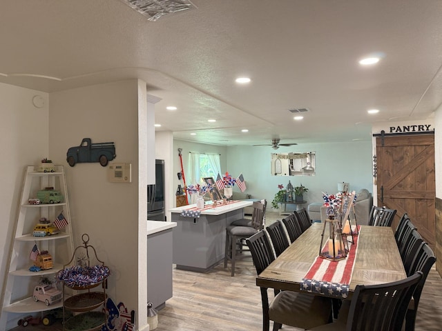 605 E Davis Dr, Dinuba, CA 93618 - dining room featuring a barn door, light wood finished floors, recessed lighting, and ceiling fan