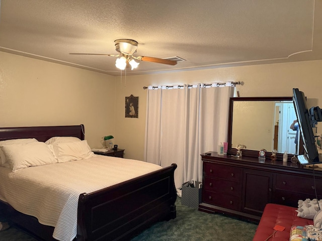 605 E Davis Dr, Dinuba, CA 93618 - bedroom with dark colored carpet, ceiling fan, and a textured ceiling