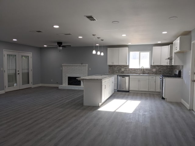 1468 Browning Ave, Clovis, CA 93611 - kitchen featuring appliances with stainless steel finishes, light wood finished floors, backsplash, white cabinets, and recessed lighting