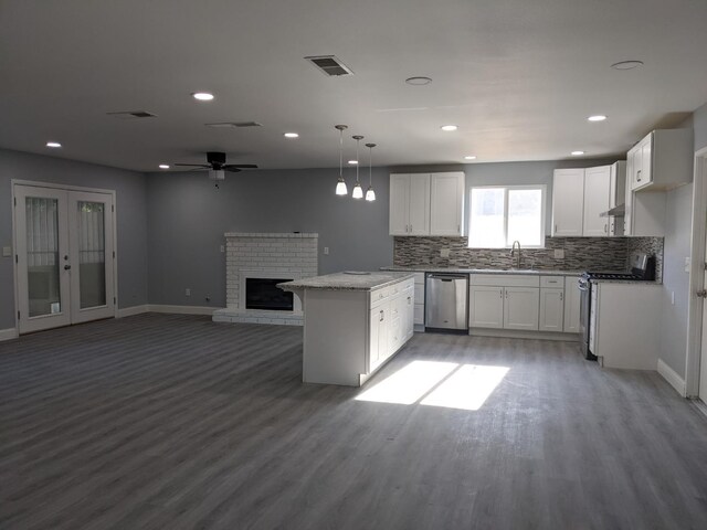 1468 Browning Ave, Clovis, CA 93611 - kitchen featuring appliances with stainless steel finishes, light wood finished floors, backsplash, white cabinets, and recessed lighting