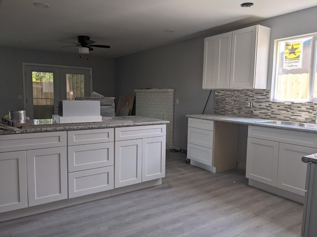 1468 Browning Ave, Clovis, CA 93611 - kitchen with a ceiling fan, healthy amount of natural light, light wood finished floors, and white cabinetry