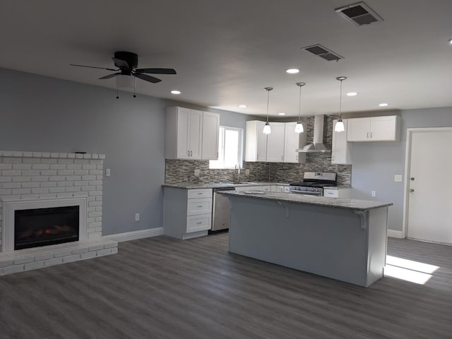 1468 Browning Ave, Clovis, CA 93611 - kitchen with appliances with stainless steel finishes, wall chimney range hood, backsplash, a kitchen island, and recessed lighting