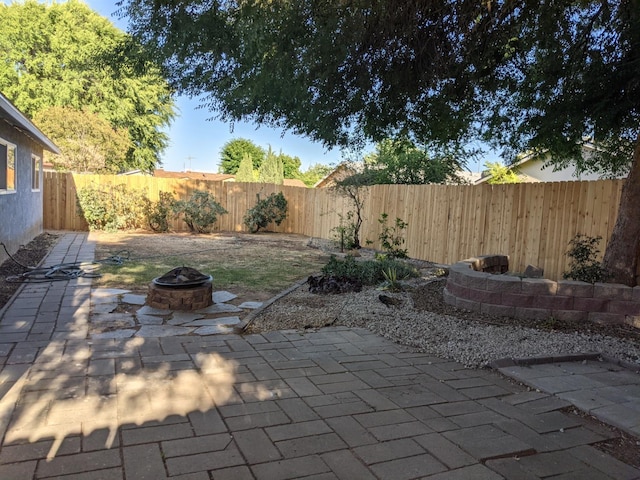1468 Browning Ave, Clovis, CA 93611 - fenced backyard with an outdoor fire pit and a patio area
