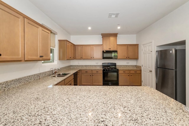 17 Medieval, Merced, CA 95341 - kitchen with black appliances, light stone counters, recessed lighting, and a peninsula