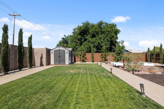 17 Medieval, Merced, CA 95341 - fenced backyard with a storage unit and a vegetable garden