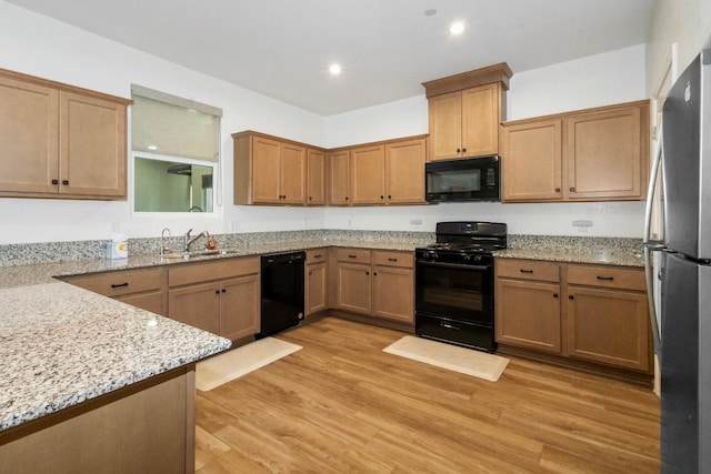 17 Medieval, Merced, CA 95341 - kitchen featuring black appliances, light stone countertops, light wood-type flooring, and recessed lighting