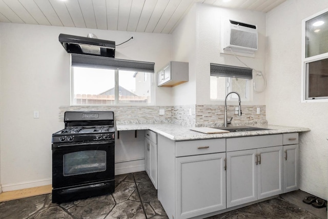 17 Medieval, Merced, CA 95341 - kitchen with black gas range oven, wood ceiling, backsplash, and a wall mounted AC